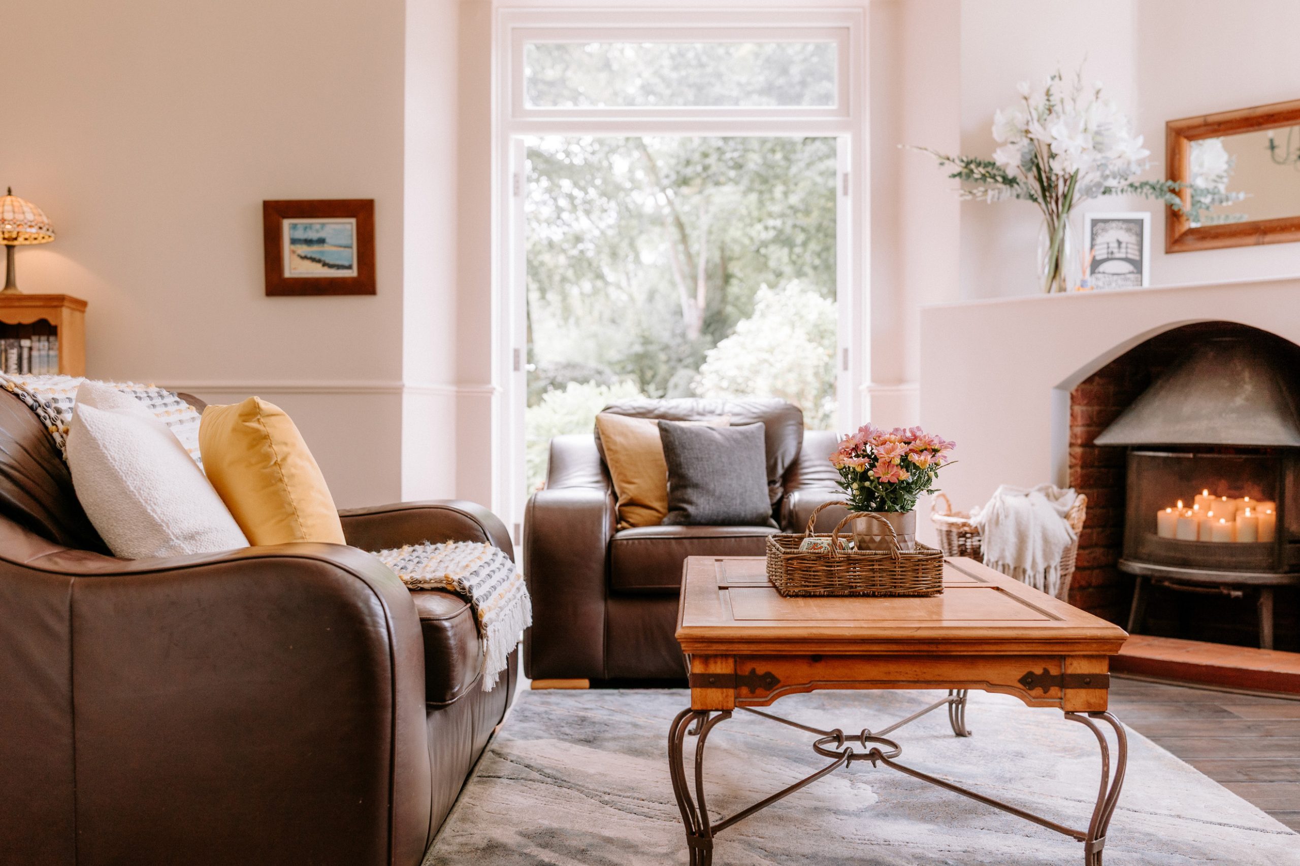 Cosy living room staged and styled with candles and fresh flowers, prepared by J Lord & Co as part of bespoke property marketing in Cheshire