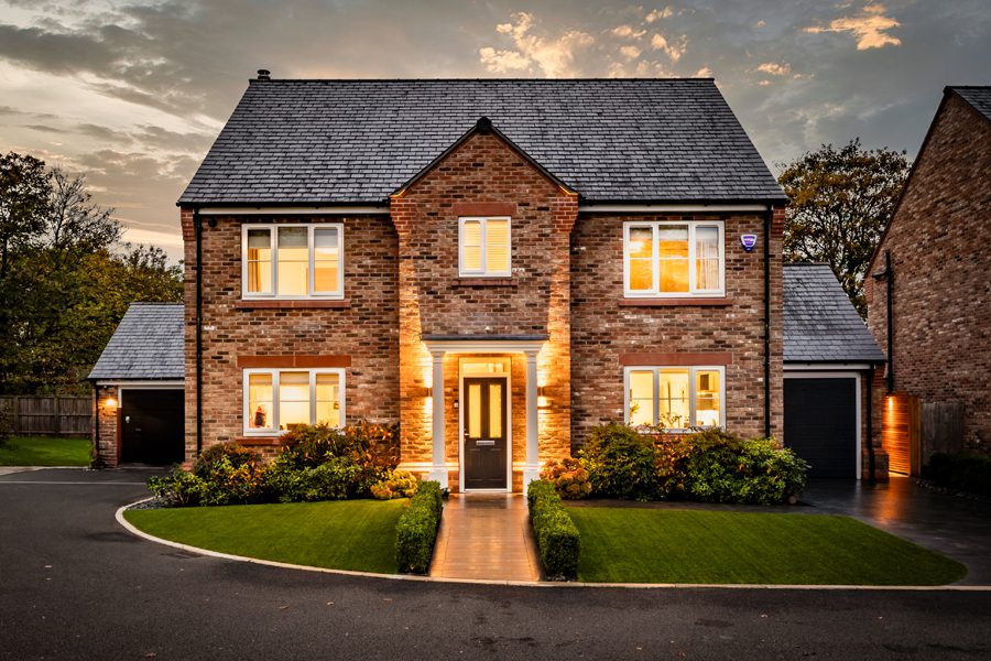 Evening exterior of a detached Davenham home with large landscaped garden