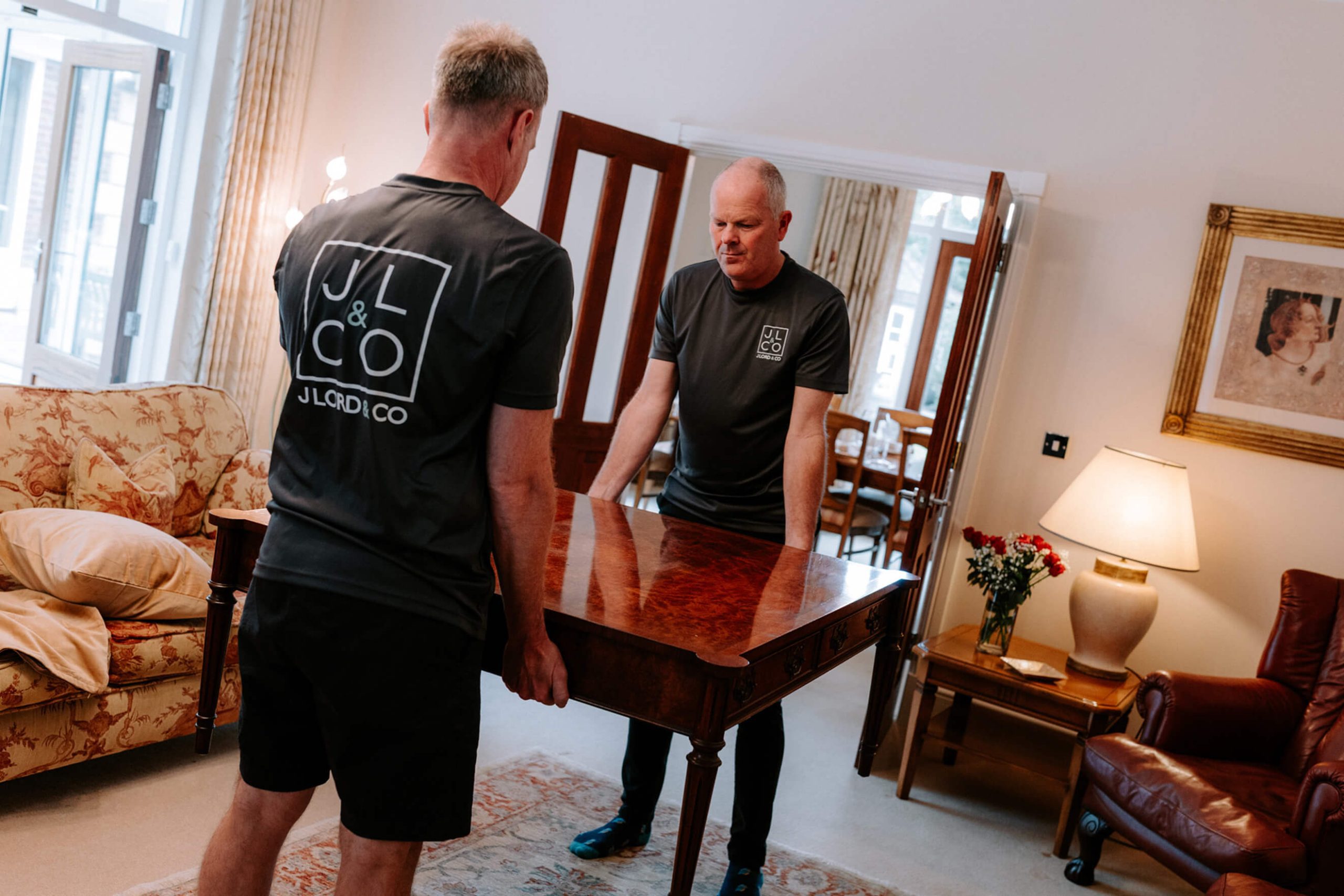 J Lord & Co home staging team preparing a dining room table as part of property styling in Cheshire.