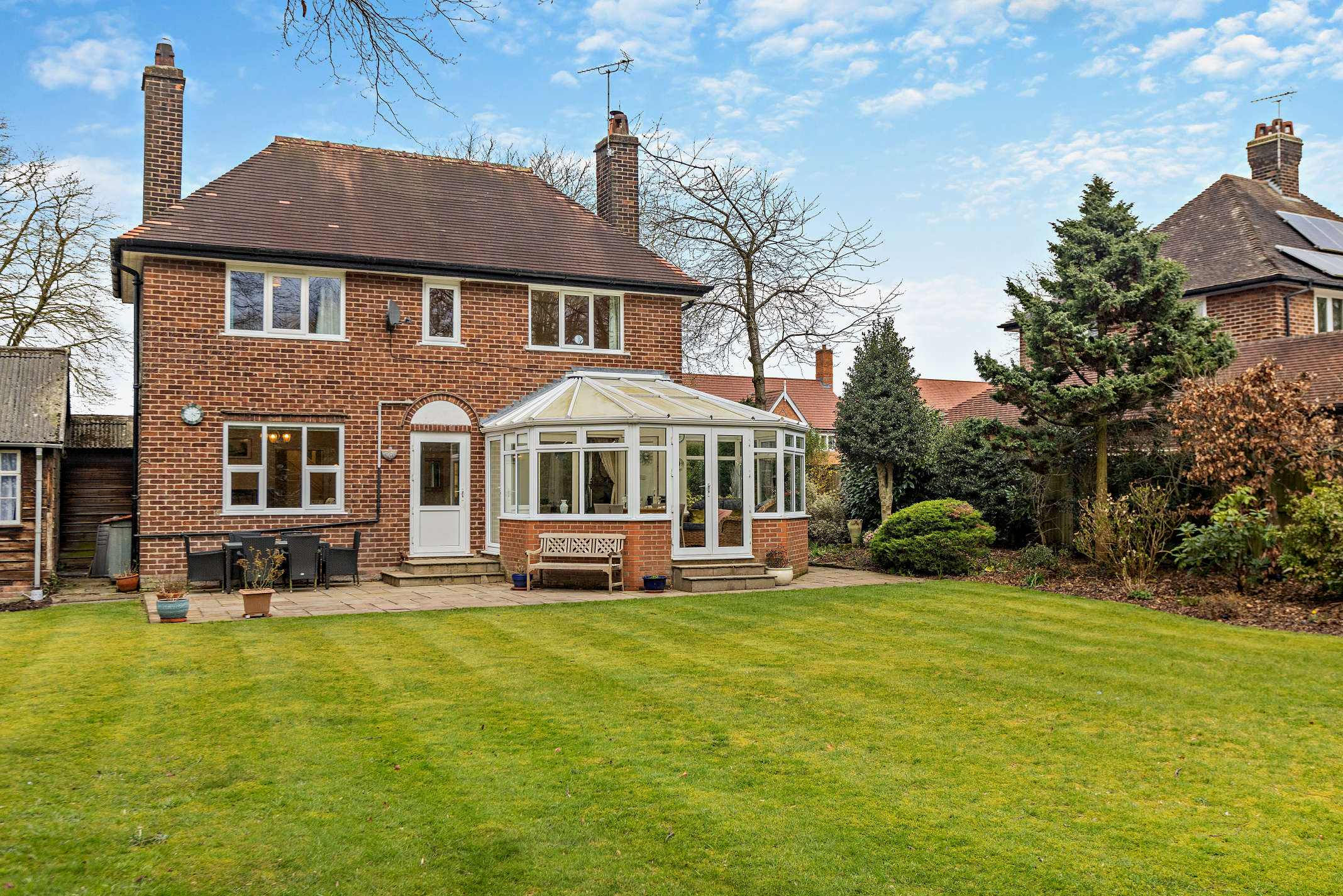 Rear exterior of detached home with conservatory and patio on Walnut Lane Hartford