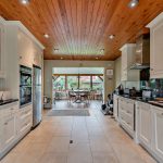 Kitchen diner with shaker cabinets and wooden ceiling at Thornycroft, Cuddington.