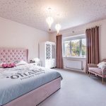 Spacious children’s bedroom with pink upholstered bed, star-print ceiling and warm natural light at 4 Bell Crescent, Davenham.