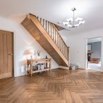 Bespoke modern home in Northwich featuring spacious hallway with oak finishes and modern lighting