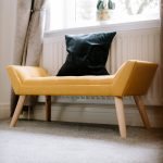 Luxury Cheshire home in Northwich highlighting bright hallway with statement yellow chair and natural light.