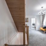 Northwich featuring hallway with oak staircase, soft furnishings and modern lighting.