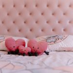 Playful children’s bedroom with pink button-tufted headboard and heart-shaped plush toys in a Davenham Cheshire home