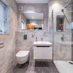 Contemporary ensuite shower room with large format grey tiles, rainfall shower and wall-hung vanity at 4 Bell Crescent, Davenham.