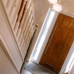 Entrance hallway with oak front door and feature lighting in a Kingsmead Cheshire home.