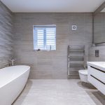 Luxury family bathroom with freestanding bath, textured feature wall and sleek contemporary fittings at 4 Bell Crescent, Davenham.