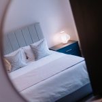 Minimalist guest bedroom with soft grey headboard and white bedding in a Davenham Cheshire property for sale