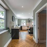 High-specification property in Northwich with open kitchen layout and herringbone flooring leading to garden view