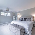 Generous master bedroom with king-size bed, neutral tones, and ensuite access at Davenham Court