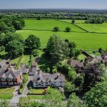 Aerial image capturing Gladstone Cottage and surrounding open countryside in Davenham, Cheshire.