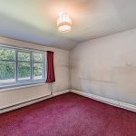 Principal bedroom at Gladstone Cottage showing generous proportions and renovation potential.