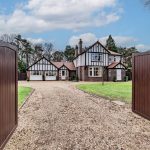 Front gated entrance and sweeping gravel driveway leading to Kennelwood, Sandiway Cheshire