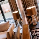 Warmly lit lounge corner with reflection of table lamp and garden views in a Davenham Cheshire property for sale