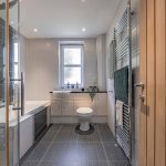 Luxury home in Northwich with a sleek bathroom design, tiled finishes and contemporary chrome fittings