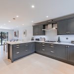 Luxury kitchen with dark Shaker cabinets, stainless appliances and white quartz worktops in a Davenham Cheshire property.