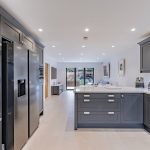 Contemporary open-plan kitchen, dining and living space with bi-fold doors leading to the garden in Davenham Cheshire.