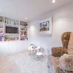 Bespoke playroom with built-in shelving, toys and reading area in a family home in Davenham Cheshire.