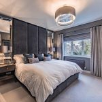 Principal bedroom with bespoke dressing area and illuminated display storage in a Davenham Cheshire home.