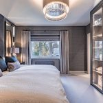 Principal bedroom featuring statement headboard, chandelier and layered textures in a Davenham Cheshire property for sale.