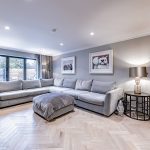 Spacious lounge featuring large corner sofa, herringbone flooring and garden views in a Davenham Cheshire property for sale.