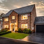 Front driveway and illuminated façade of 4 Bell Crescent, Davenham, Cheshire at dusk, showcasing modern exterior lighting.
