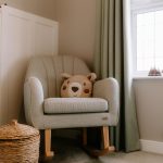 Cosy nursery corner with soft green rocking chair and warm natural accents at 9 Mereheath Close, Davenham.