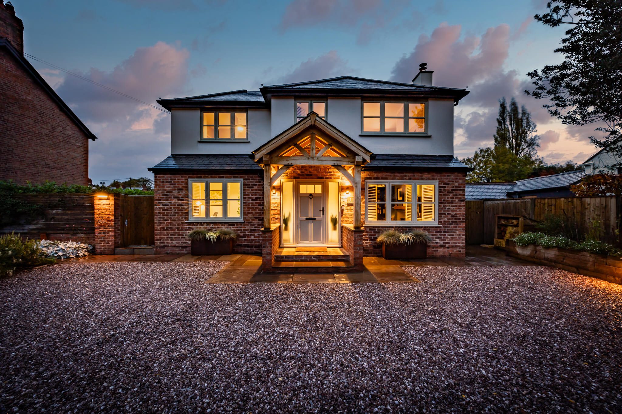 Evening front elevation of the detached home on Church Street, Davenham highlighting the symmetrical façade and oak framed entrance