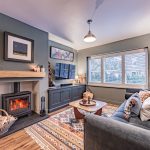 Immaculate main lounge at a Church Street, Davenham home featuring a wood burning stove, floating oak mantel and heritage-toned décor