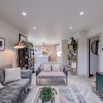 Open plan living space at a detached home on Church Street, Davenham with herringbone flooring, seating area and kitchen beyond