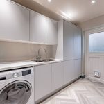 Practical utility room at a Church Street, Davenham home with fitted cabinetry, integrated appliances and side access door