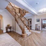 Grand entrance hall with split staircase and wood flooring at 3 The Woodlands, Hartford.