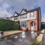 Front elevation of 32 Hartford Road with driveway parking and bay window.