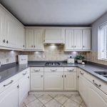 Modern fitted kitchen with rear access at 23 Pulford Close, Kingsmead.