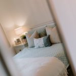 Bedroom two styling detail with bedside lighting at 24 Priory Avenue, Leftwich