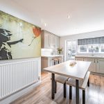 9 The Pavilions, Davenham – open plan kitchen dining space within a detached home featuring central island, shaker cabinetry and garden outlook