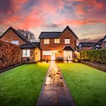 9 The Pavilions, Davenham – rear garden with paved pathway, lawn and evening lighting creating a private outdoor setting
