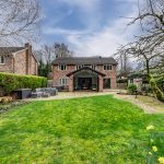 Rear elevation of detached home with patio and garden at Brock Lodge in Leftwich, Northwich