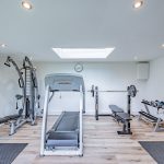 Converted garage gym space with equipment and skylight at Brock Lodge, Northwich