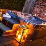 Hot tub with candles and champagne creating outdoor living atmosphere at Brock Lodge, Northwich Cheshire