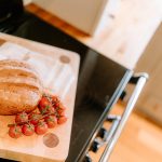 Kitchen food preparation detail with fresh bread and tomatoes at Brock Lodge, Northwich Cheshire