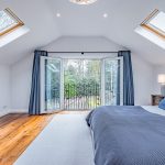 Principal bedroom with balcony overlooking garden at Brock Lodge in Leftwich, Northwich