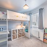Children's bedroom with bunk bed, storage and soft neutral décor in a family home in Davenham
