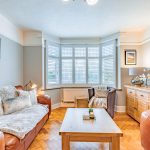 Bay window lounge with original parquet flooring and plantation shutters at 46 Hodge Lane Hartford