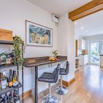 Kitchen with breakfast bar seating and view through to the garden at 46 Hodge Lane Hartford
