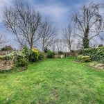 Generous rear garden with mature planting and open aspect beyond at 46 Hodge Lane Hartford