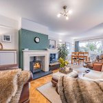 Open plan living room with log burning stove and parquet flooring at 46 Hodge Lane Hartford