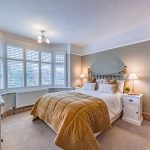 Principal bedroom with bay window and plantation shutters at 46 Hodge Lane Hartford